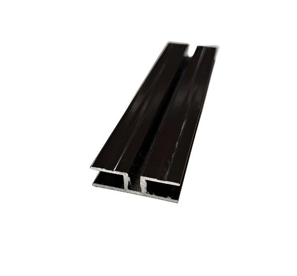 A brown aluminium extrusion insert for a half panel, laid on a white surface.